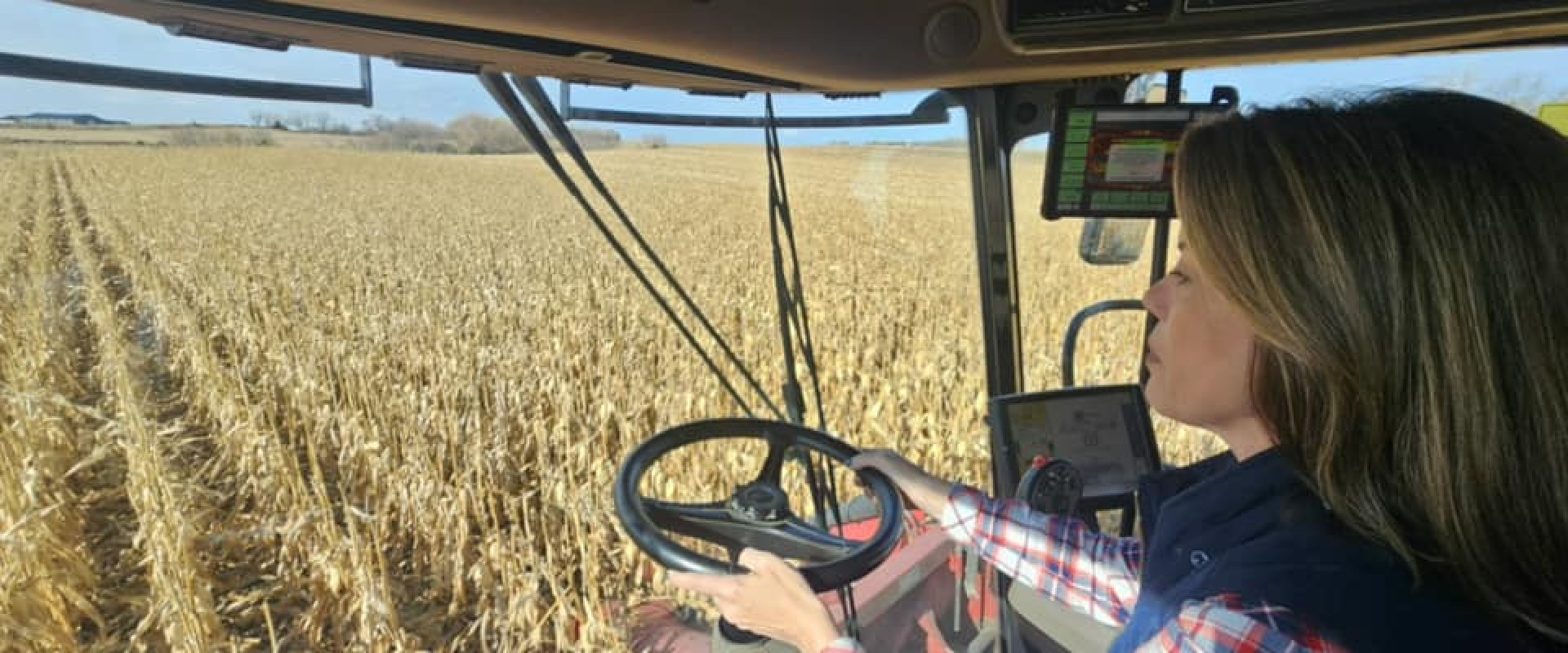 Rep. Angie Craig on a tractor at a farm