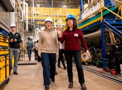 Wearing hard hats touring the plant